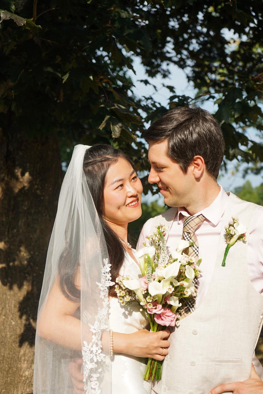 Stephen and Jenny smiling together on their wedding day